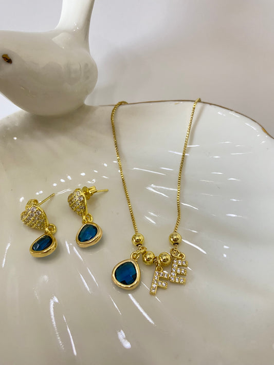 Conjunto fe con microcircones engastados en baño de oro gema azul